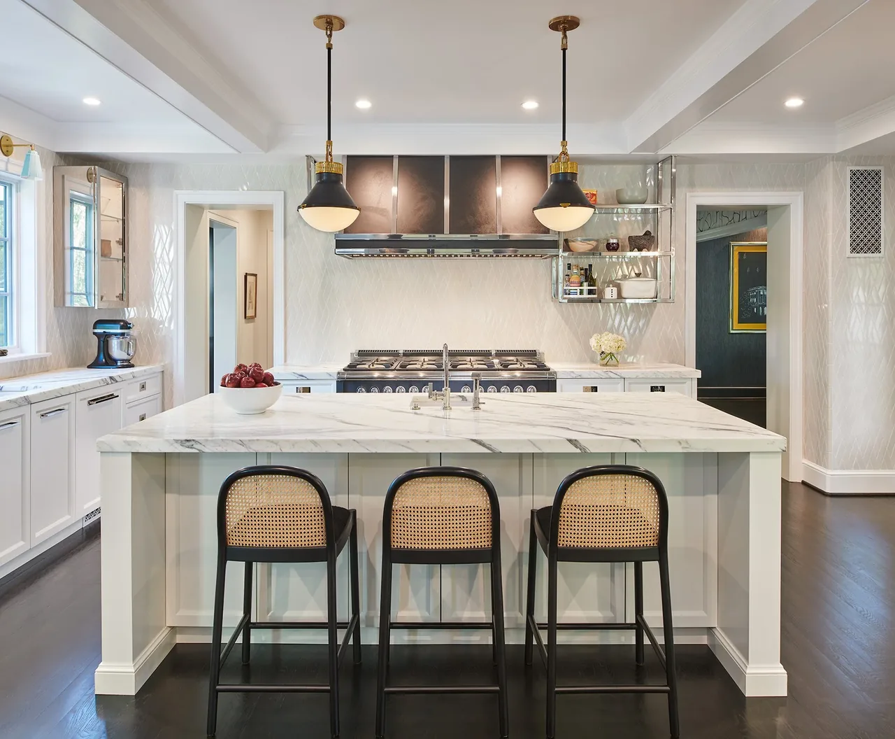 The Cathedral View kitchen features a marble island with seating, two pendant lights, and a black gas range with a vent hood.