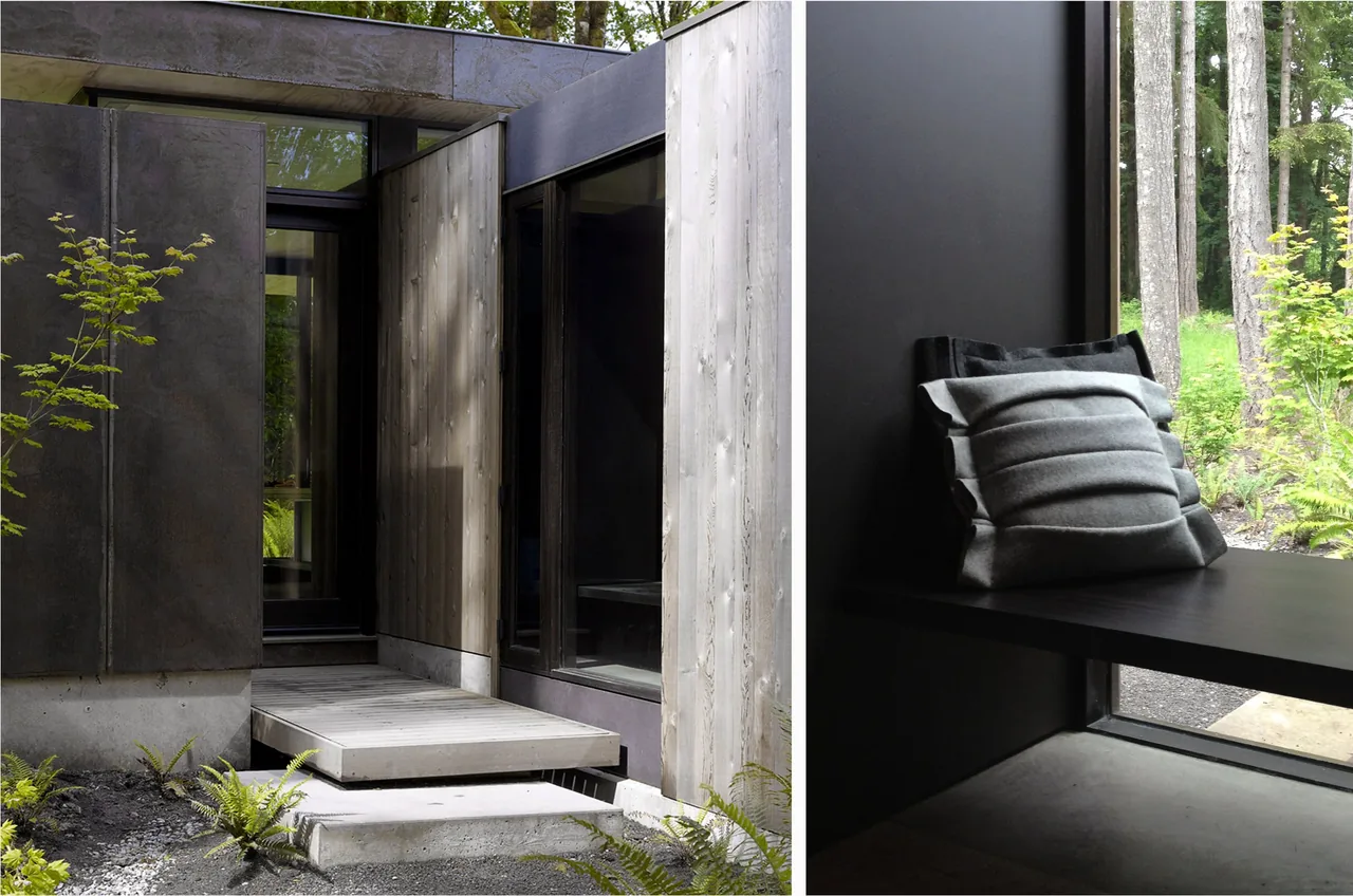 Case Inlet Retreat features wood siding and black steel panels with a built-in bench sitting area near a large window.