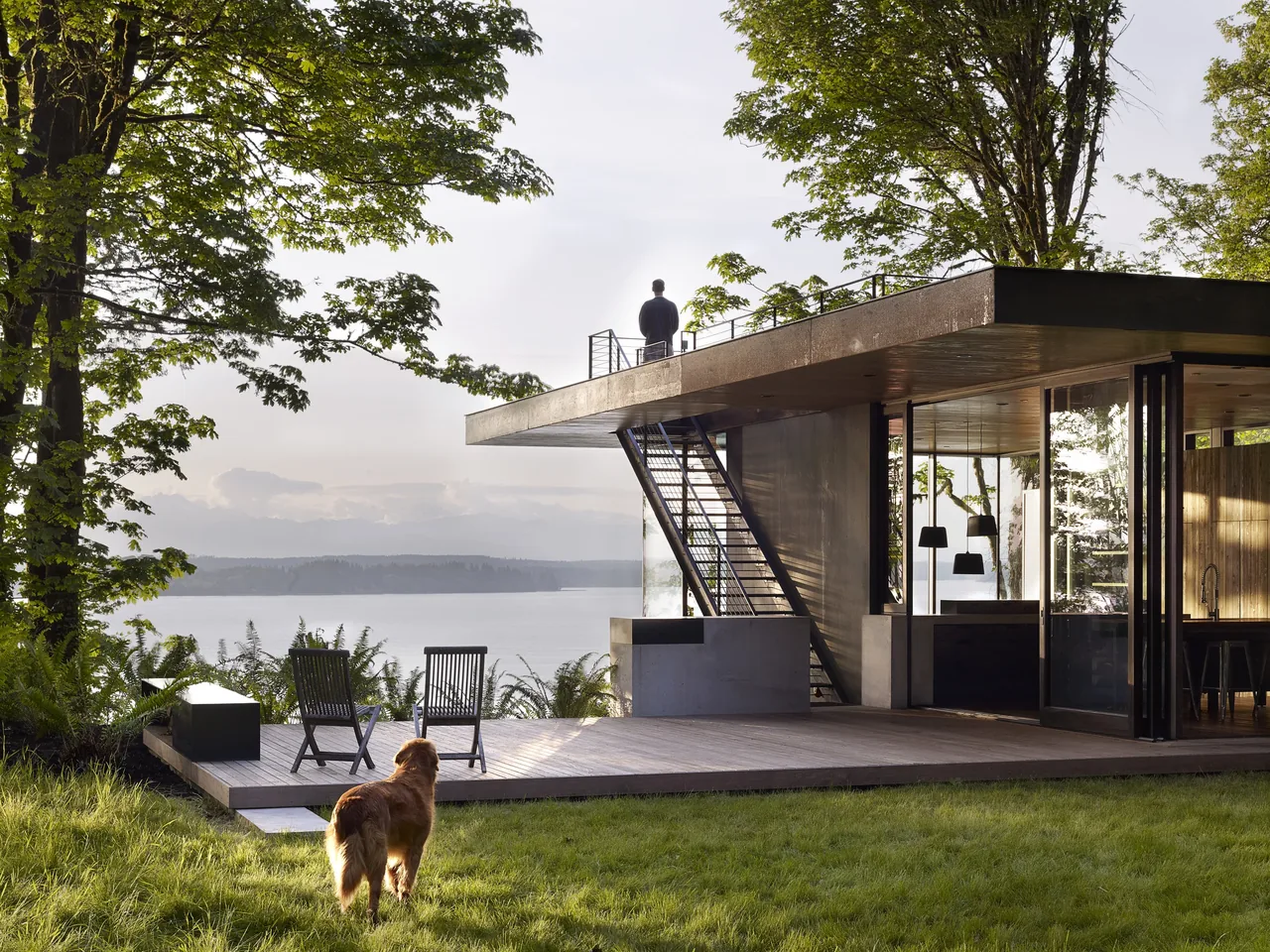 The Magnolia residence features an open outdoor deck with seating and rooftop access overlooking a lake.