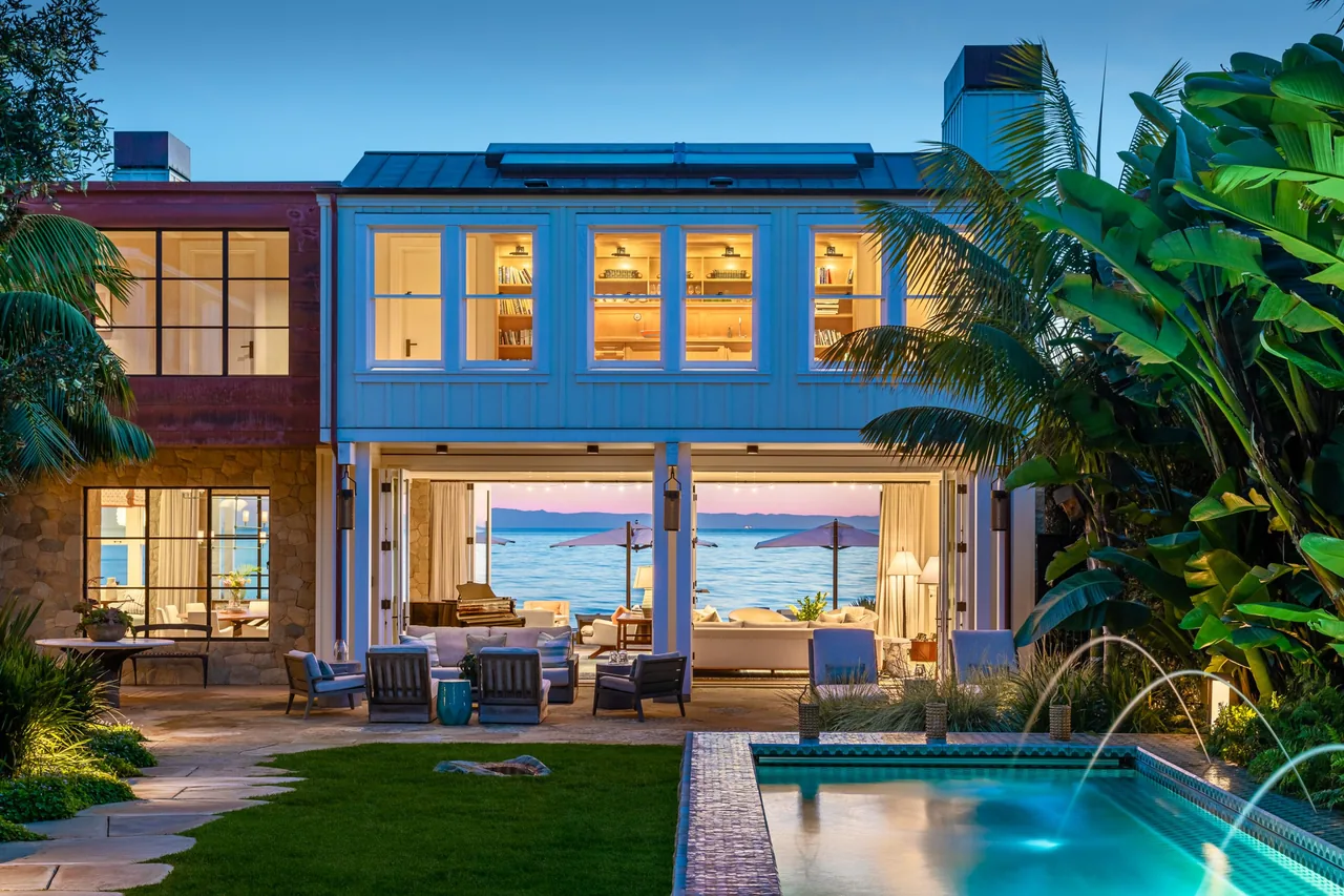 The Padaro Beach Home features a living area opening directly to an outdoor space with pool and ocean views.