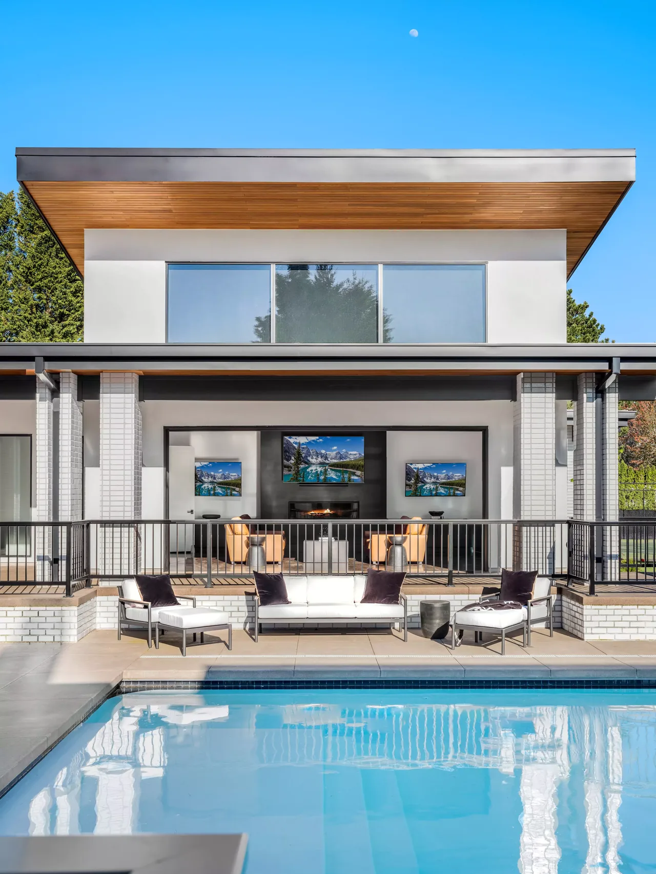 The Burton New Custom Build features a symmetrical facade with a covered patio and pool area in Portland.