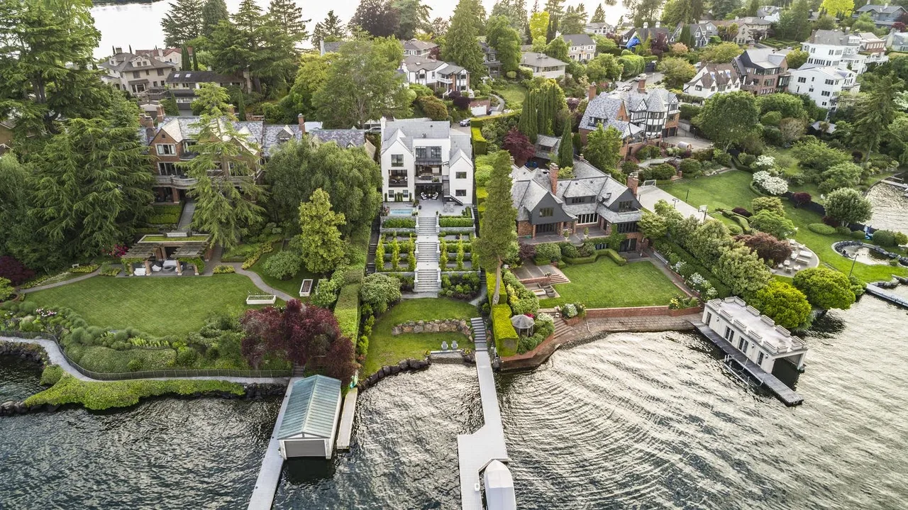 Laurelhurst Contemporary features a white multi-level home with terraced landscaping and private dock on the lakefront.