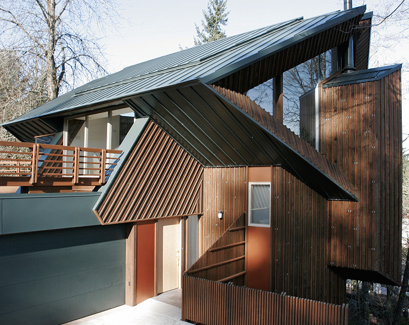 Fennel Residence features a sharp angular standing seam metal roof with vertical wood siding by Robert Harvey Oshatz Architect.