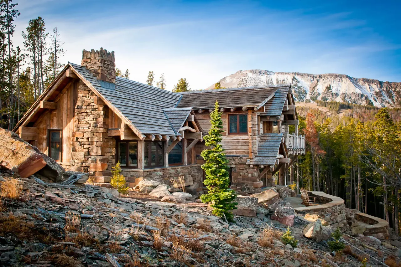 Chalet Redux features stone and wood materials with a forest and mountain setting, designed by Pearson Design Group.