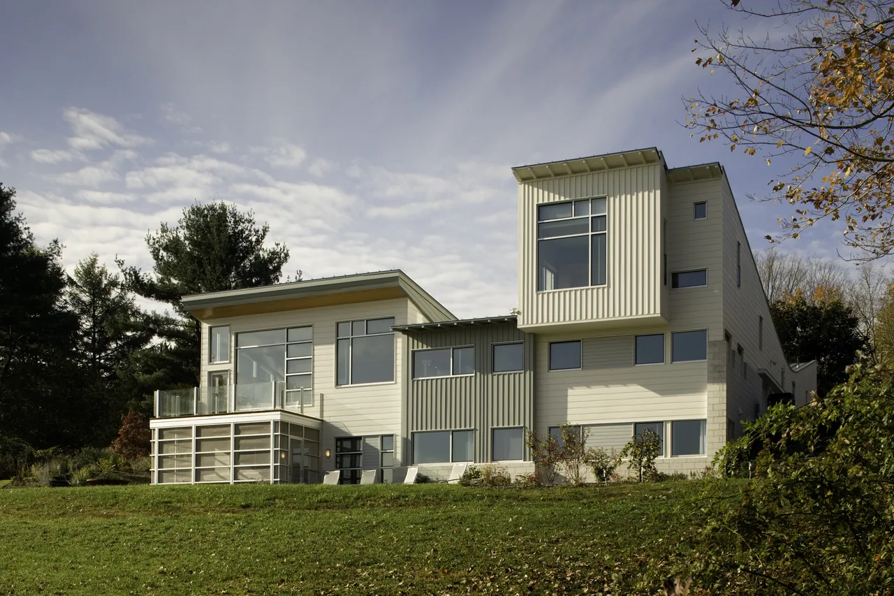 Modern-style residence featuring sloped rooflines and a mix of horizontal siding and corrugated metal panels.