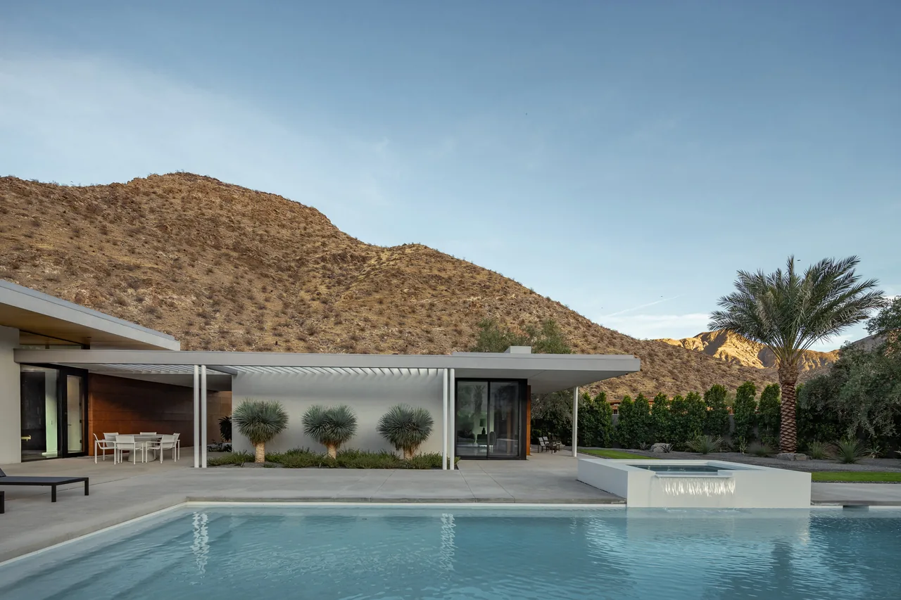 Sky Ridge features a modern residence with a pool, covered patio, and desert landscaping with mountain backdrop.