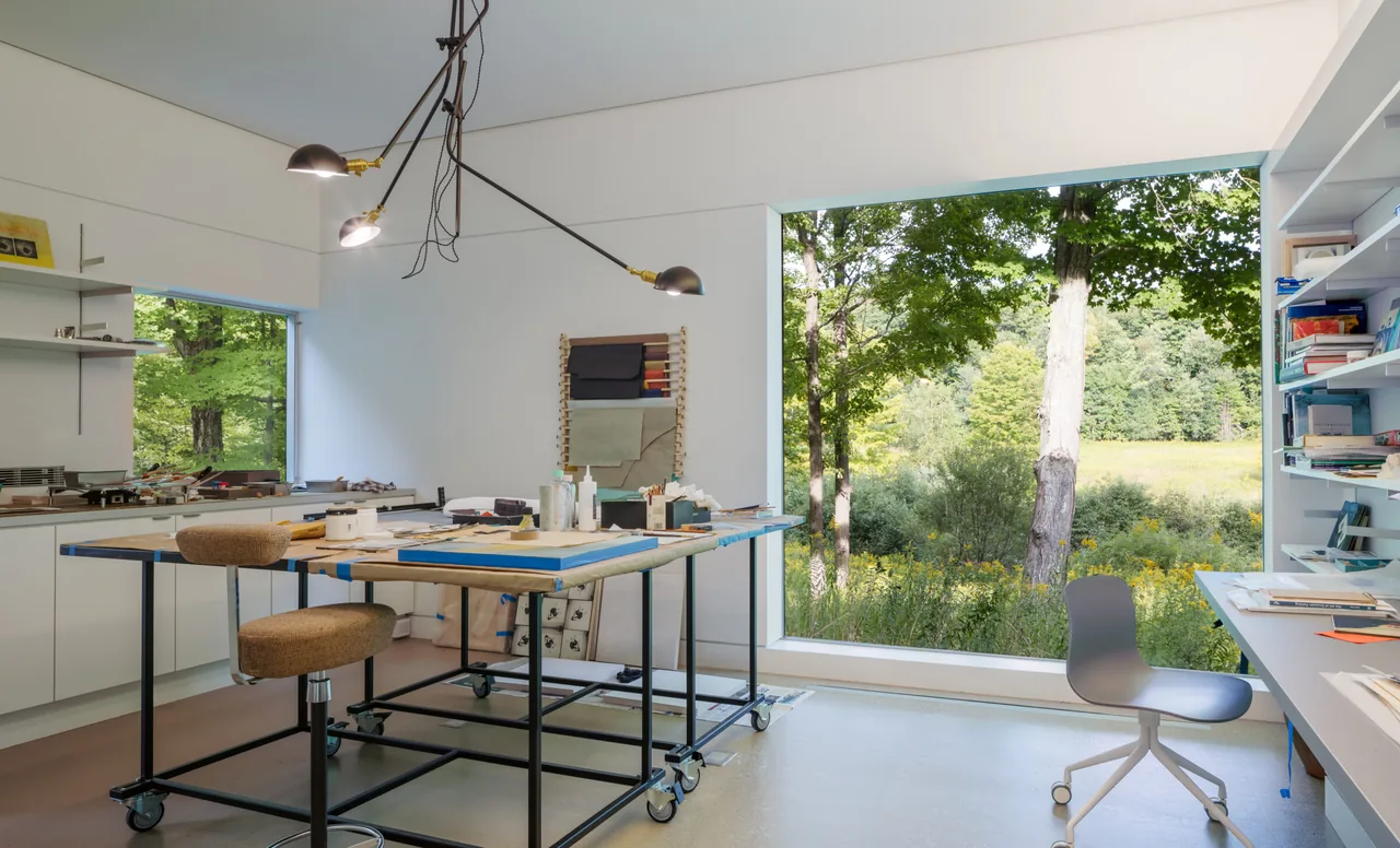 Artist Retreat workroom featuring a large corner window framing outdoor nature views.
