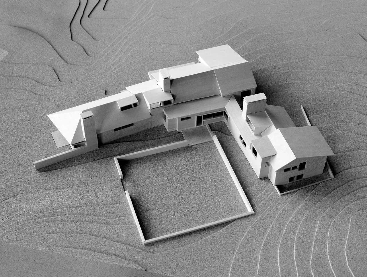Model of the Vineyard Residence shows the home's roof forms and siting on a contoured site near the ocean.