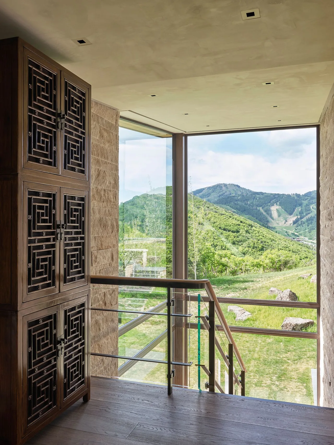 Stair landing at Morning Star Residence with large glazed window showcasing mountain views.