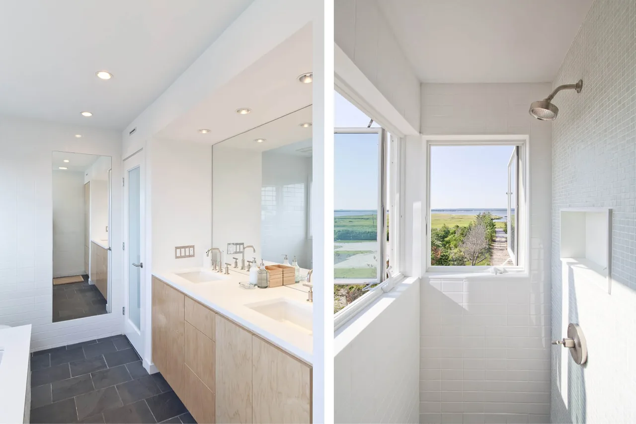 Bathroom featuring a double vanity with wood cabinetry and a tiled shower with a view to the outdoors.