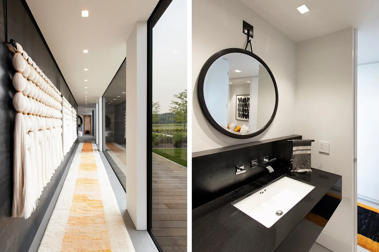 Interior view showing a hallway with knotted fabric wall art and a modern bathroom vanity with a round mirror