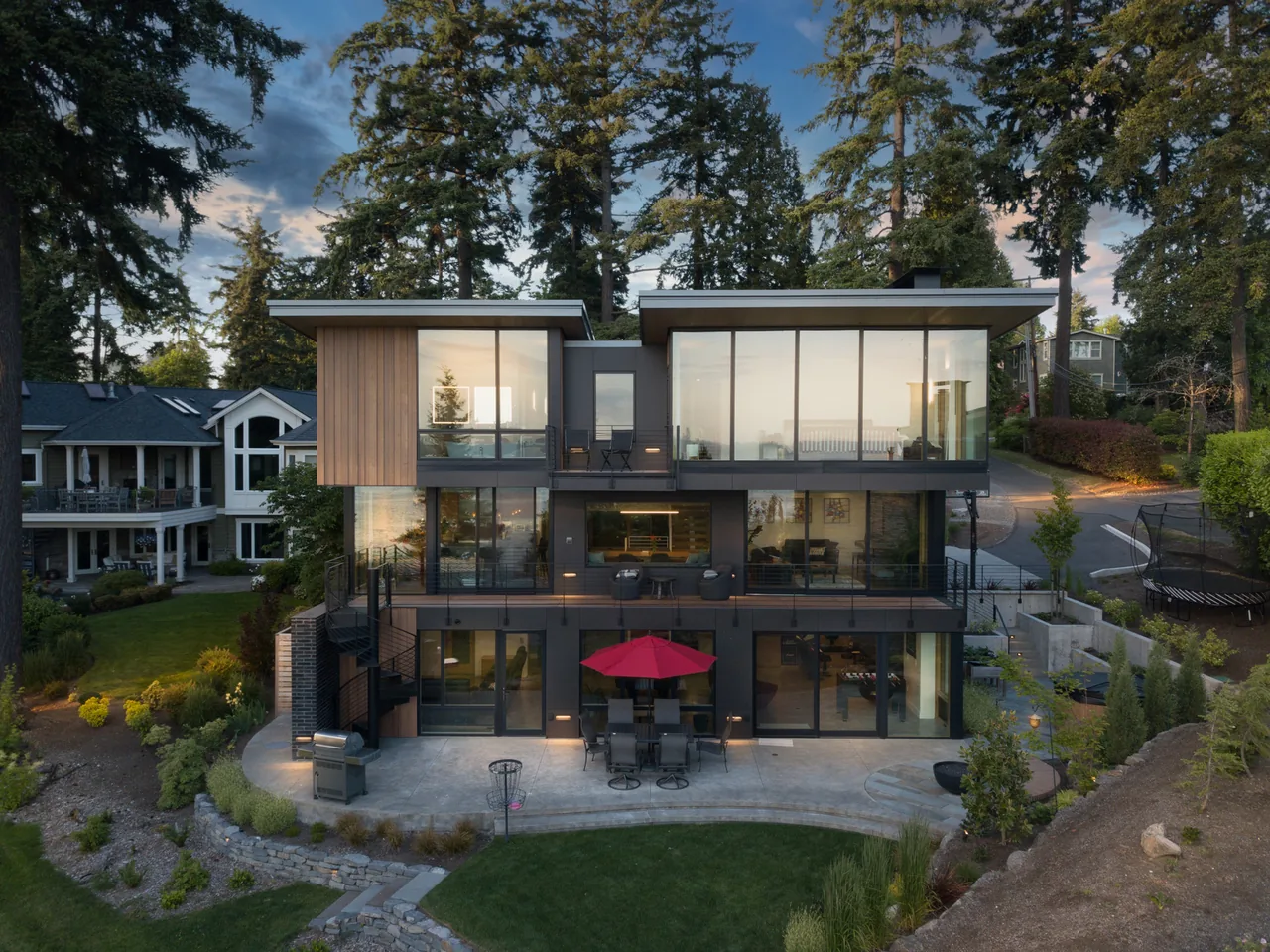 The Wingspan Residence features large floor-to-ceiling glazing and metal railings on balconies over three levels.