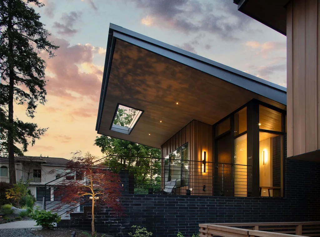 The Wingspan Residence showcases a modern exterior with a cantilevered shed roof and large windows by Rhodes Architecture + Light.