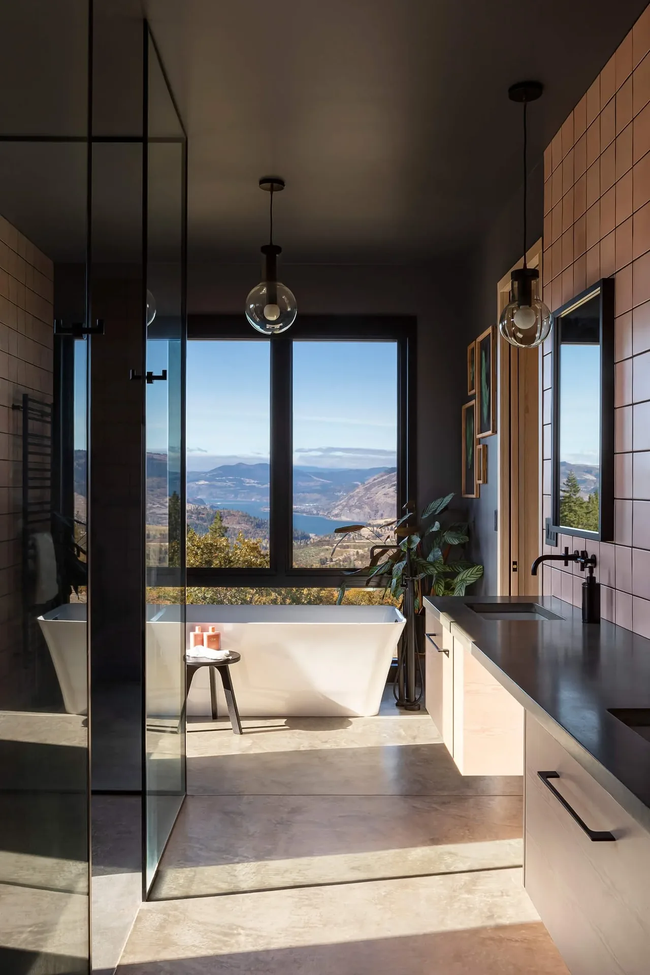 Bathroom in Mosier House features a freestanding tub with large rectangular window for scenic views.