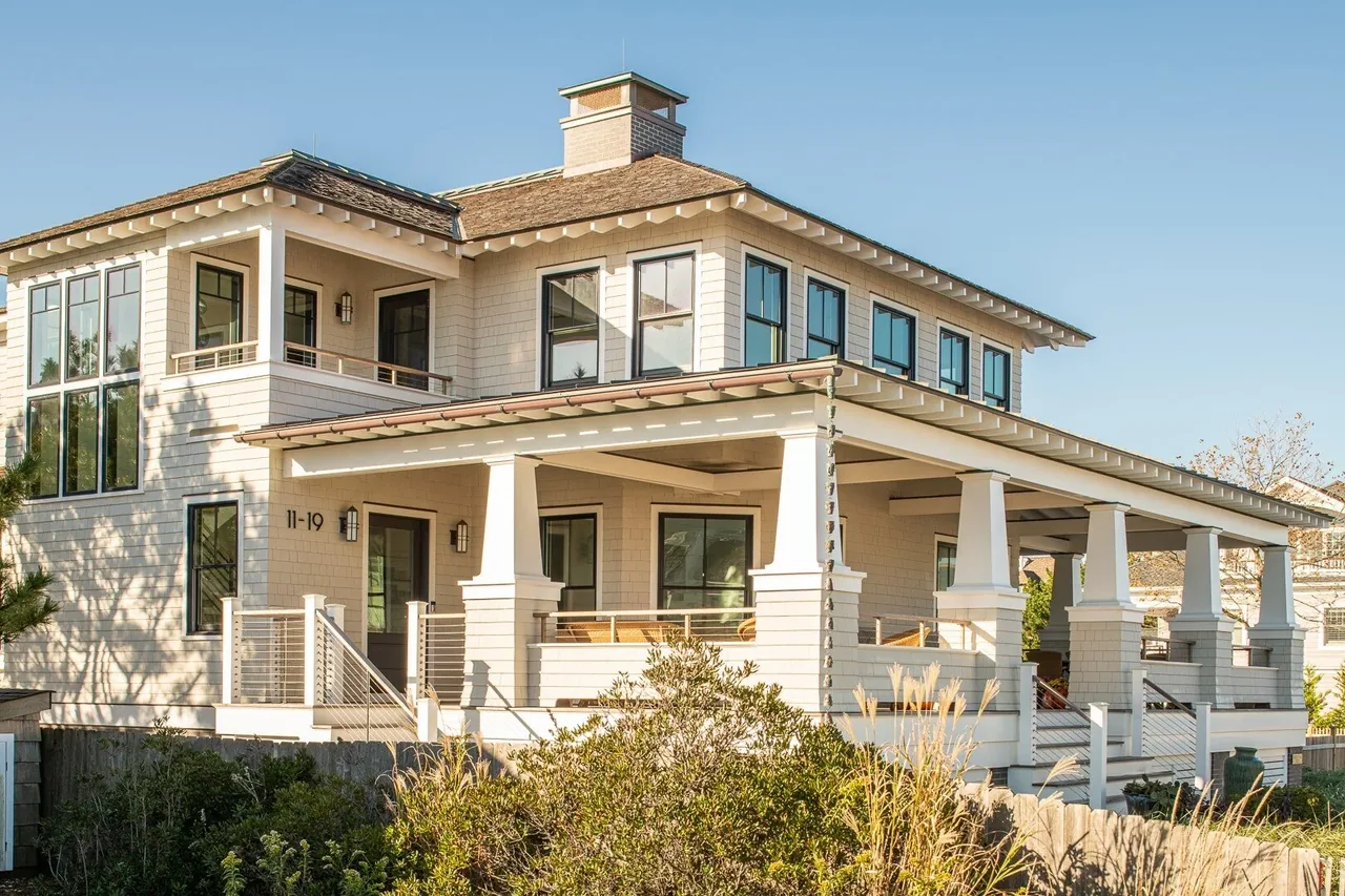 Porch Talk House in Seaside Park features a hip roof, tapered porch columns, and multiple black window frames.