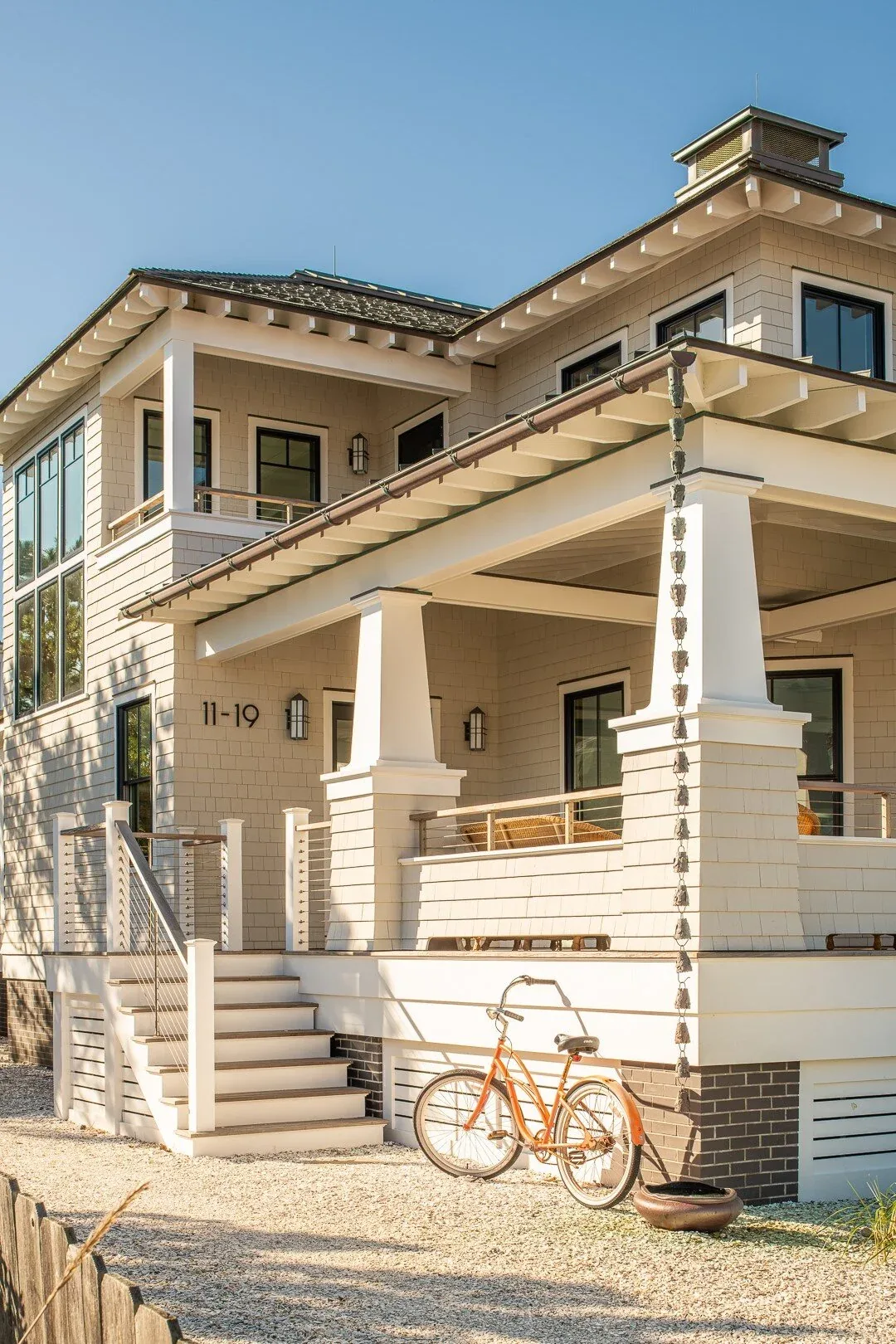 The Porch Talk House in Seaside Park has tapered porch columns and black window frames under a hip roof.