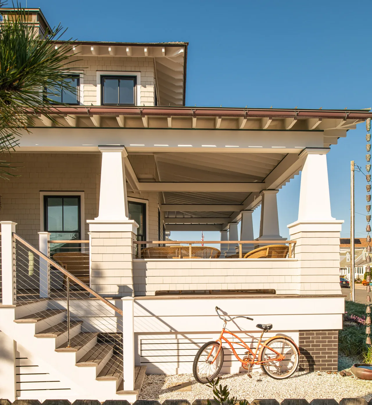 Porch Talk House features a broad front porch with tapered square columns and black-framed windows.