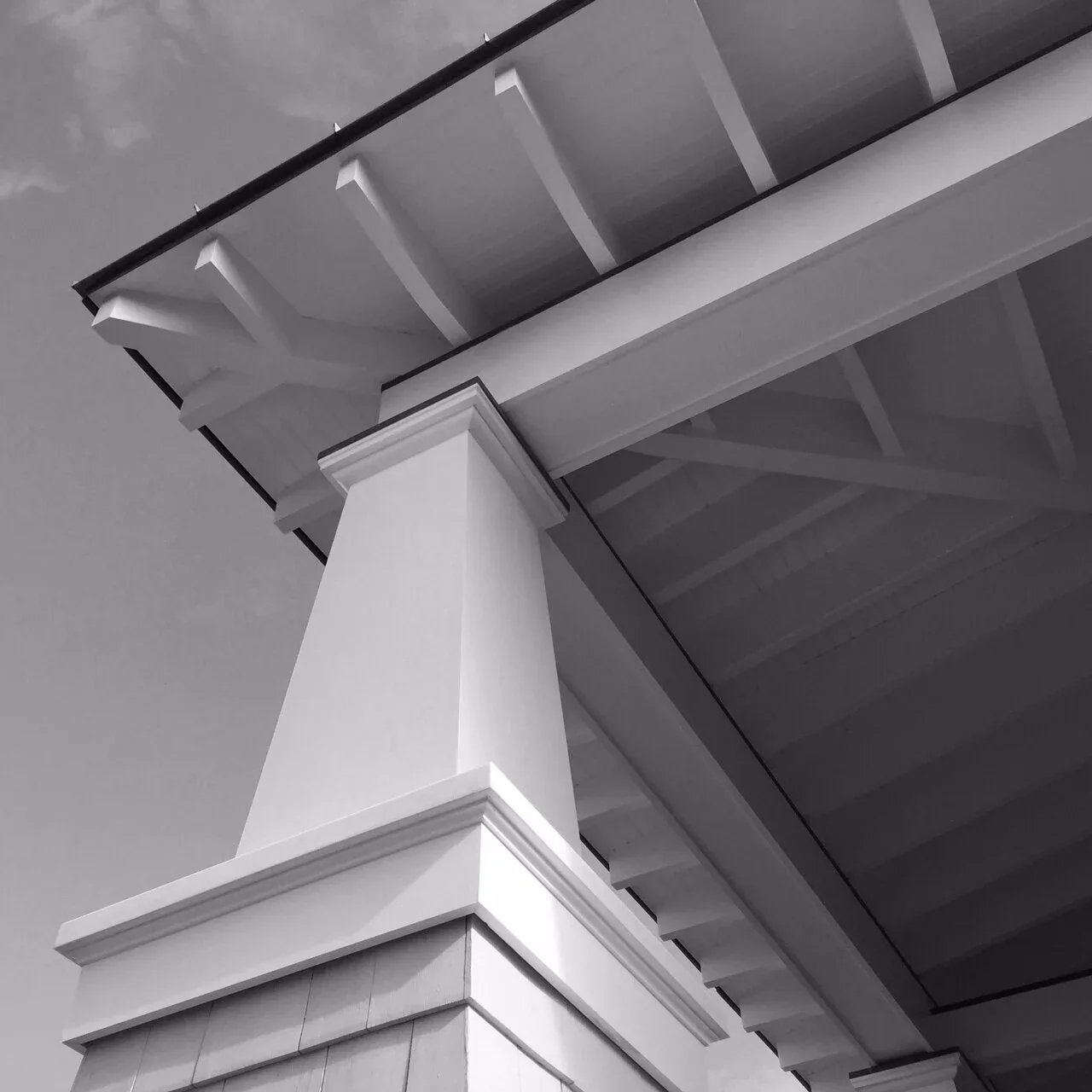 Tapered porch column supporting a roof with exposed beams at Porch Talk House, Seaside Park.