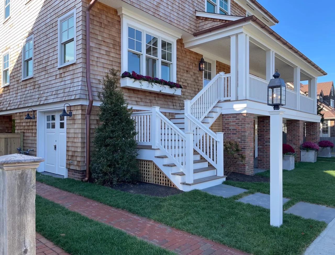The Hagerstrom residence features white handrails on exterior stairs and wood shingle siding.