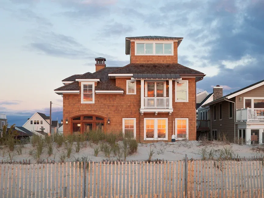 The South Surf Road beach house in Silver Beach features traditional shingle siding and multiple roof lines.