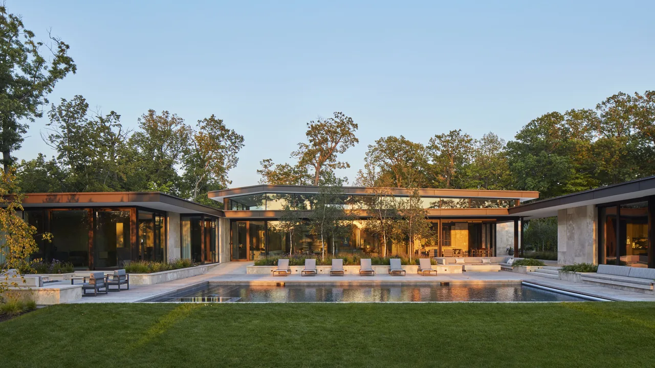 Western Retreat features a contemporary design with flat roofs and extensive glazing around a pool area.
