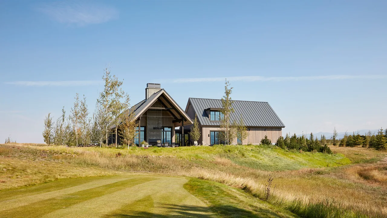Modern wood house with standing seam metal roof and large glass windows at Western Retreat.