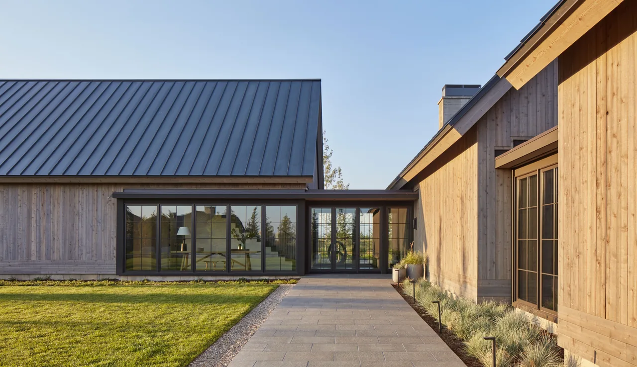 The Western Retreat features wood siding with black window frames and a standing seam metal roof.