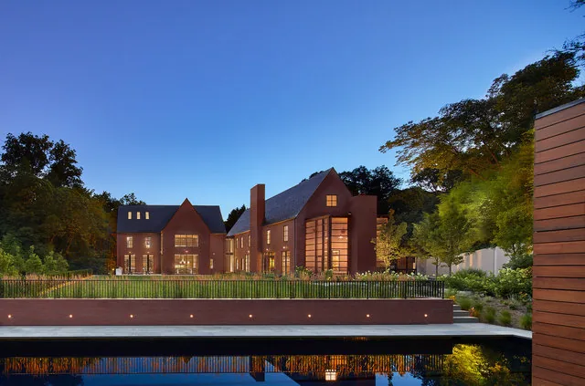 The 30TH STREET HOUSE features a symmetrical facade with steep gable roofs, tall chimney, and large rectangular windows behind an iron fence.