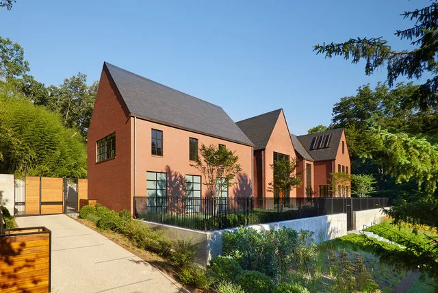 30TH STREET HOUSE features steep gable rooflines, large rectangular windows, and symmetrical design with iron fencing.