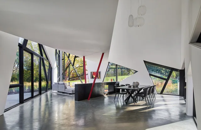 PTR HOUSE interior features angular design with triangular windows and mesh railing, by Robert Gurney Architects.