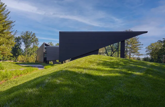 PTR HOUSE features an angular modern design with a prominent cantilevered flat roof.