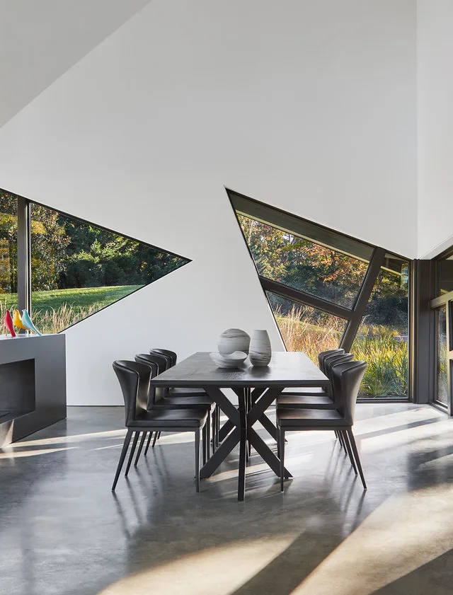 PTR House dining area features angular triangular windows and polished concrete flooring by Robert Gurney Architects.