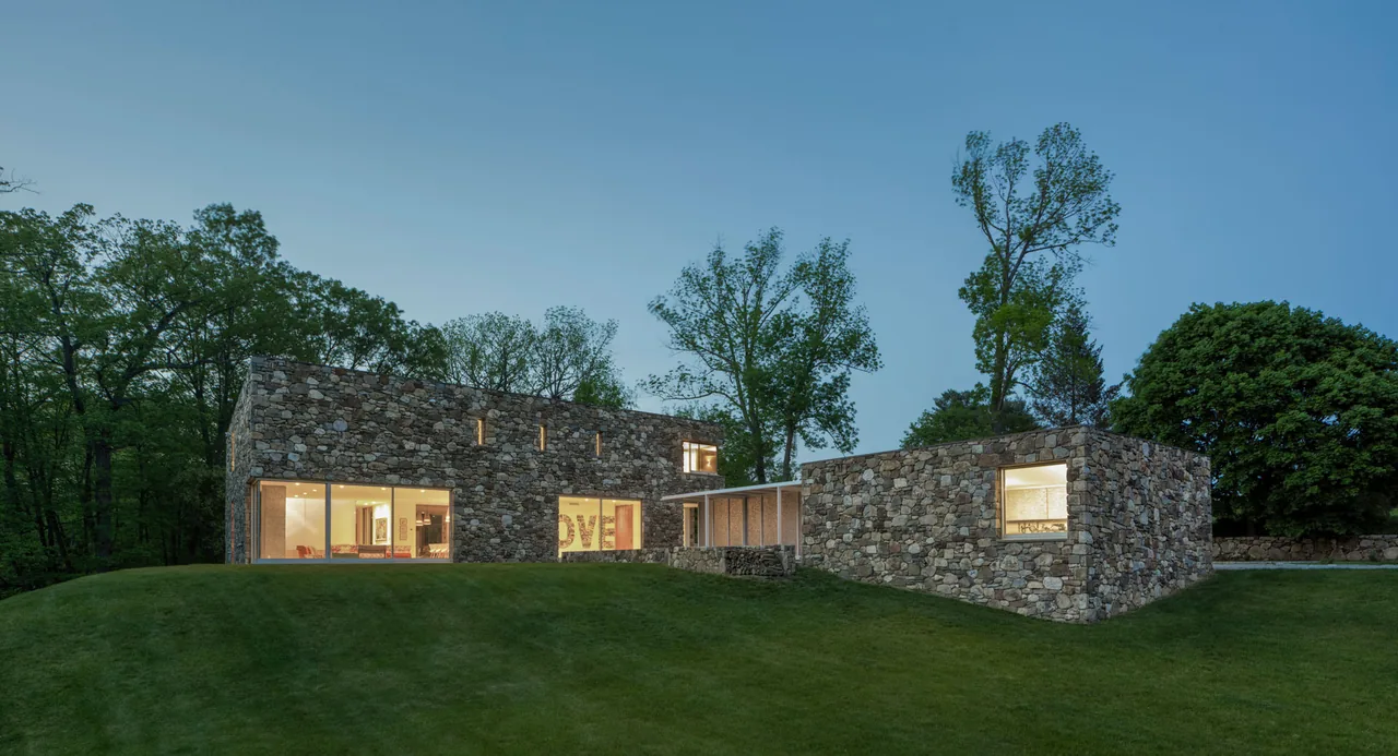 House 432 shows a stone exterior with large windows and a flat roof, set in a wooded landscape with a grassy hill.