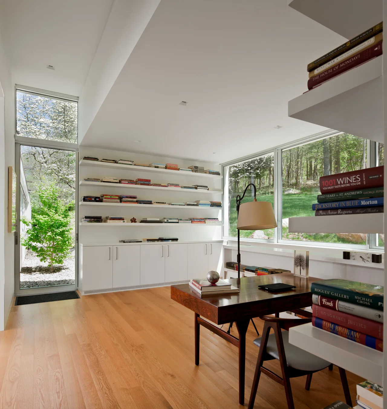 Interior of House 125 by Robert Siegel Architects showing a home office with floor-to-ceiling windows and custom built-ins.