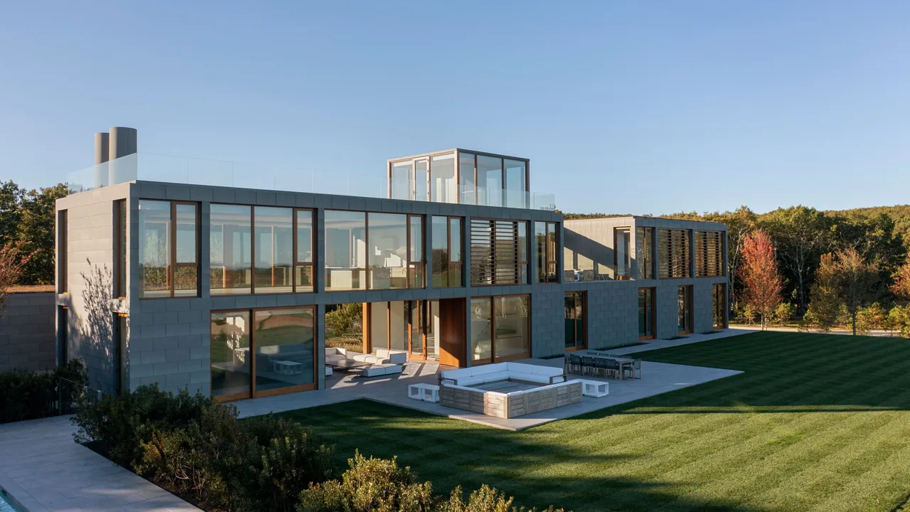 Fairway House by Roger Ferris + Partners features extensive glass walls, metal panel cladding, and outdoor seating terraces.