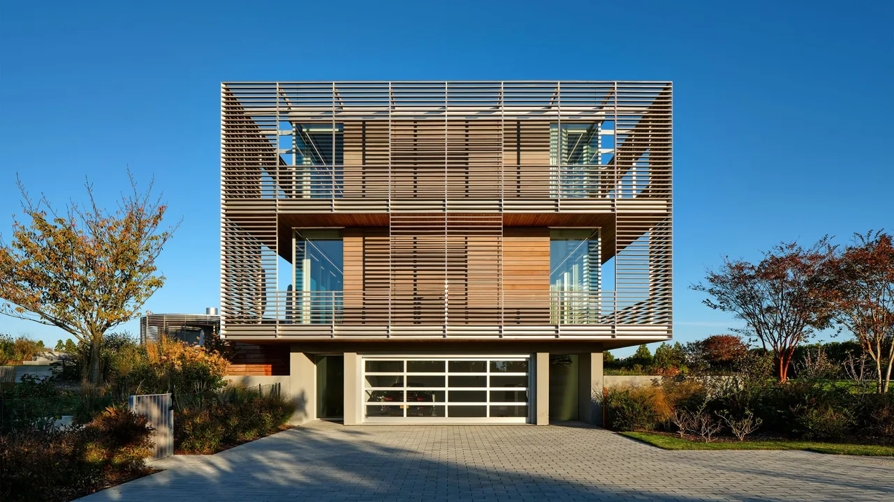 Porch House features a two-story structure with wooden slat screens and large windows, designed by Roger Ferris + Partners.