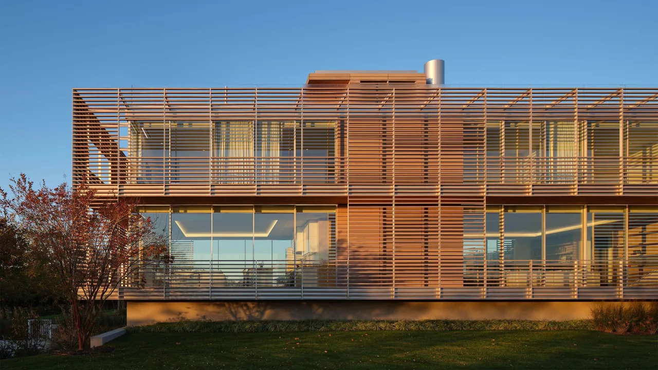 Porch House features a wooden slat screen facade that provides privacy and light control across large glass windows.