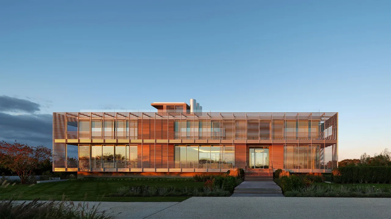 Porch House features a two-story design with wooden slat screening and large windows by Roger Ferris + Partners.