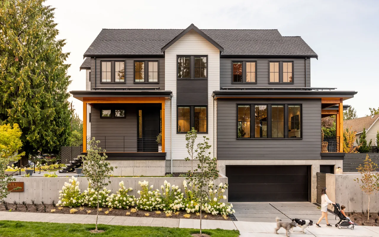 Queen Anne Transitional home by Ryan Rhodes Designs features mixed siding colors and concrete landscaping walls in Seattle.