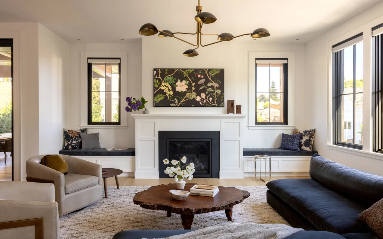 Transitional style living room with black window frames and a fireplace flanked by built-in bench seating.