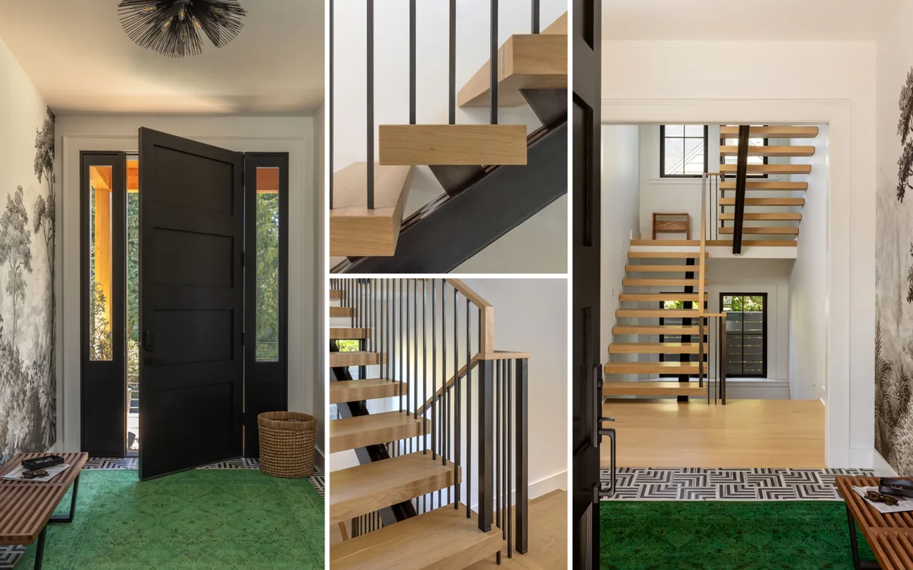 Entry features a modern floating wood staircase with black metal spindles and a black front door, accented by a green rug and wallpaper.