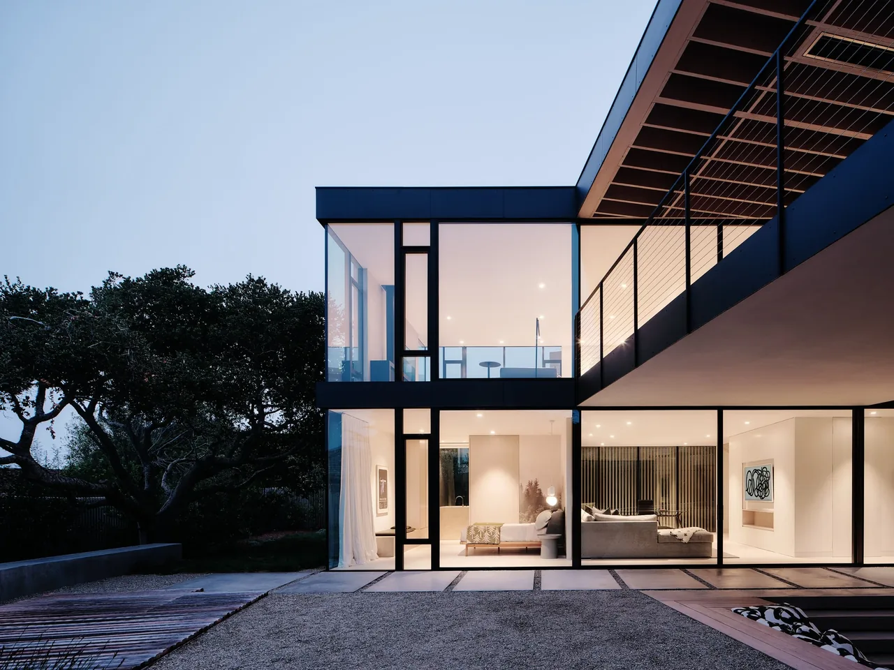 Carmel Meadows showcases a modern home with floor-to-ceiling glazing and an outdoor gravel courtyard space.