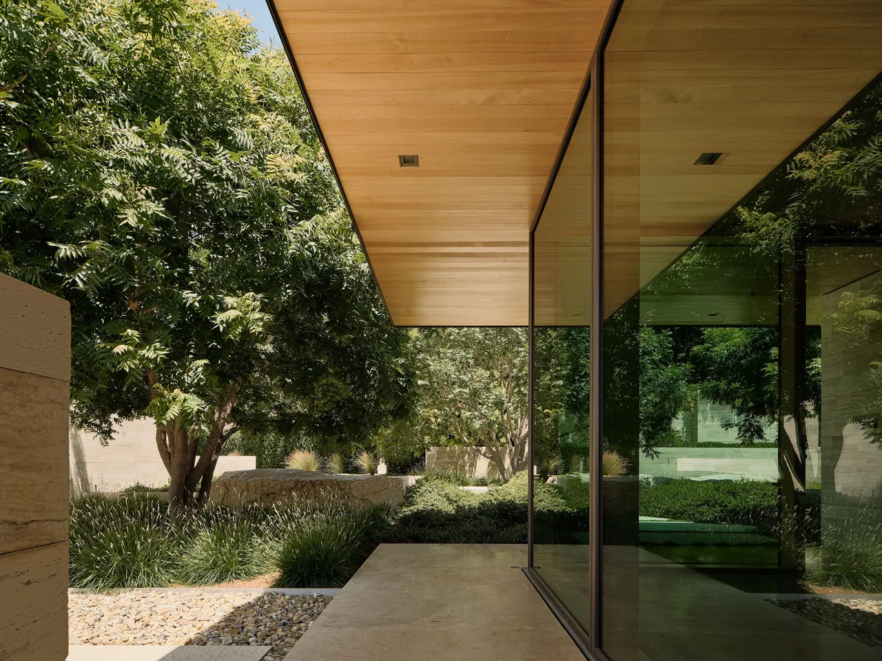 The St Helena project with wood soffits and large glass panels integrates extensive landscaping and stone steps.