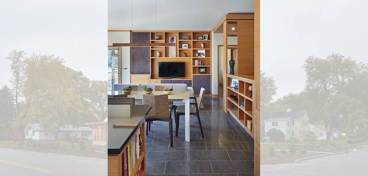 Modern dining room featuring built-in wooden shelving and a flat screen TV wall unit.