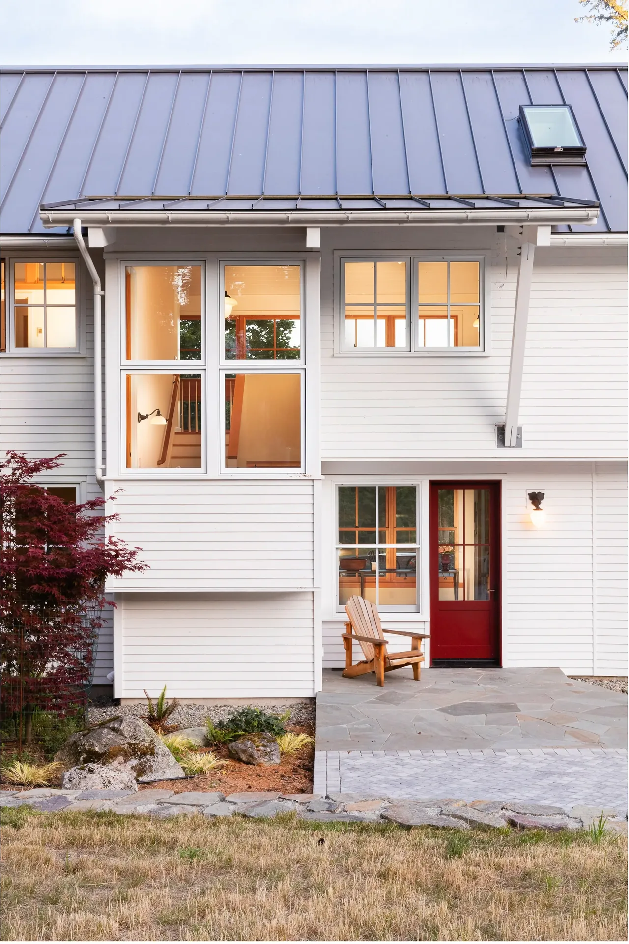 MAP CORNER house by Stoltz Kau Architects features large multi-pane windows and a metal roof in Seattle.