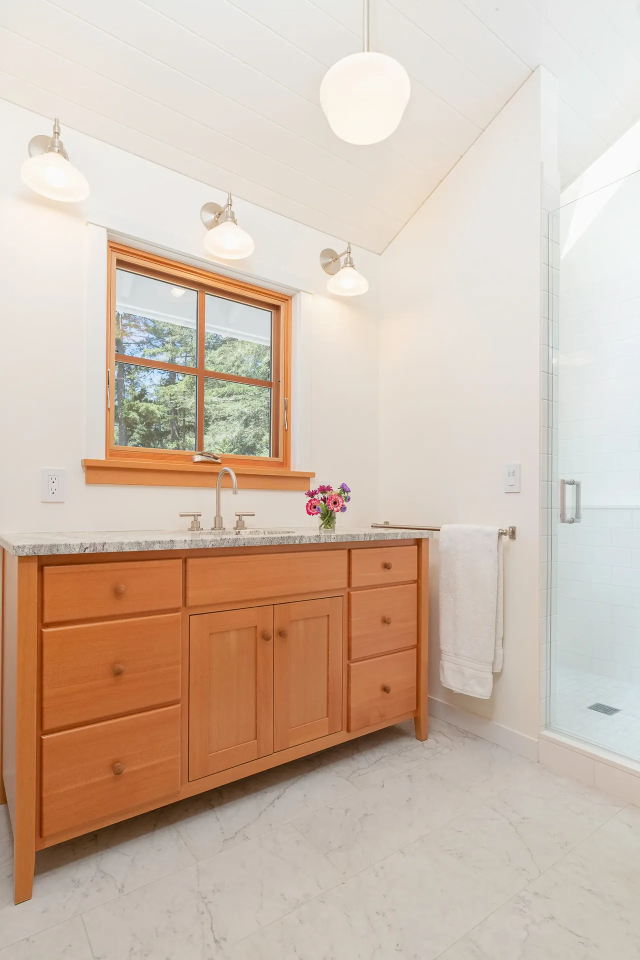 MAP CORNER bathroom features a wood vanity with granite counter and a glass shower enclosure.