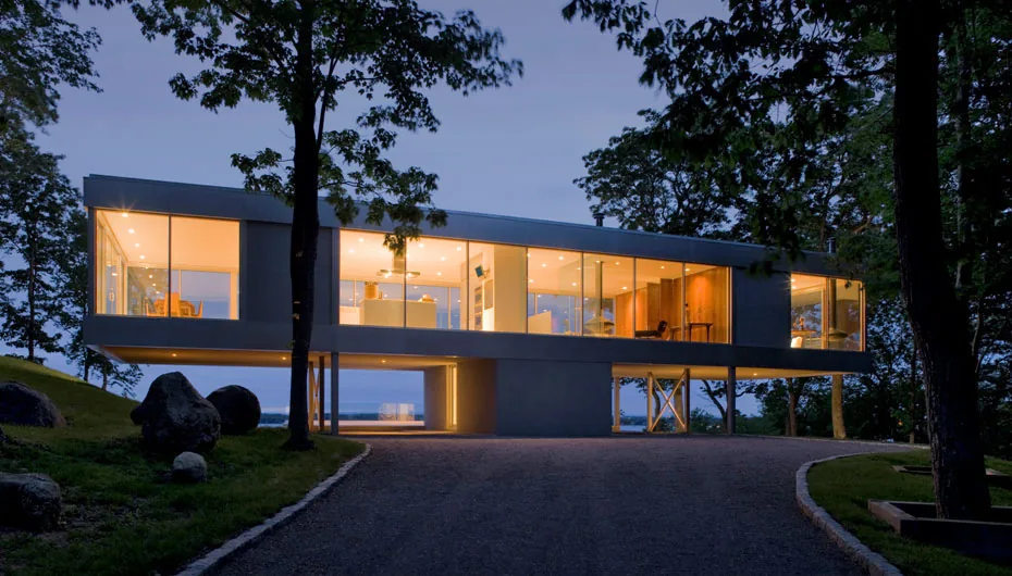 The Clearhouse features large glass walls and is raised above the ground with a view of the surrounding natural landscape.
