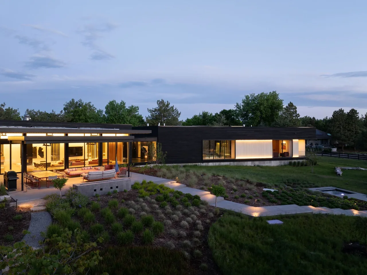 The Hunter Residence by LTBa features a modern design with expansive glazing and integrated outdoor lighting.