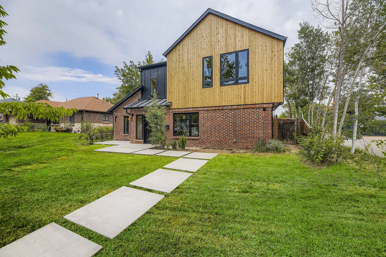 The Mod Canopy house by NAGY Design features mixed wood and brick exterior with a modern gable roof.