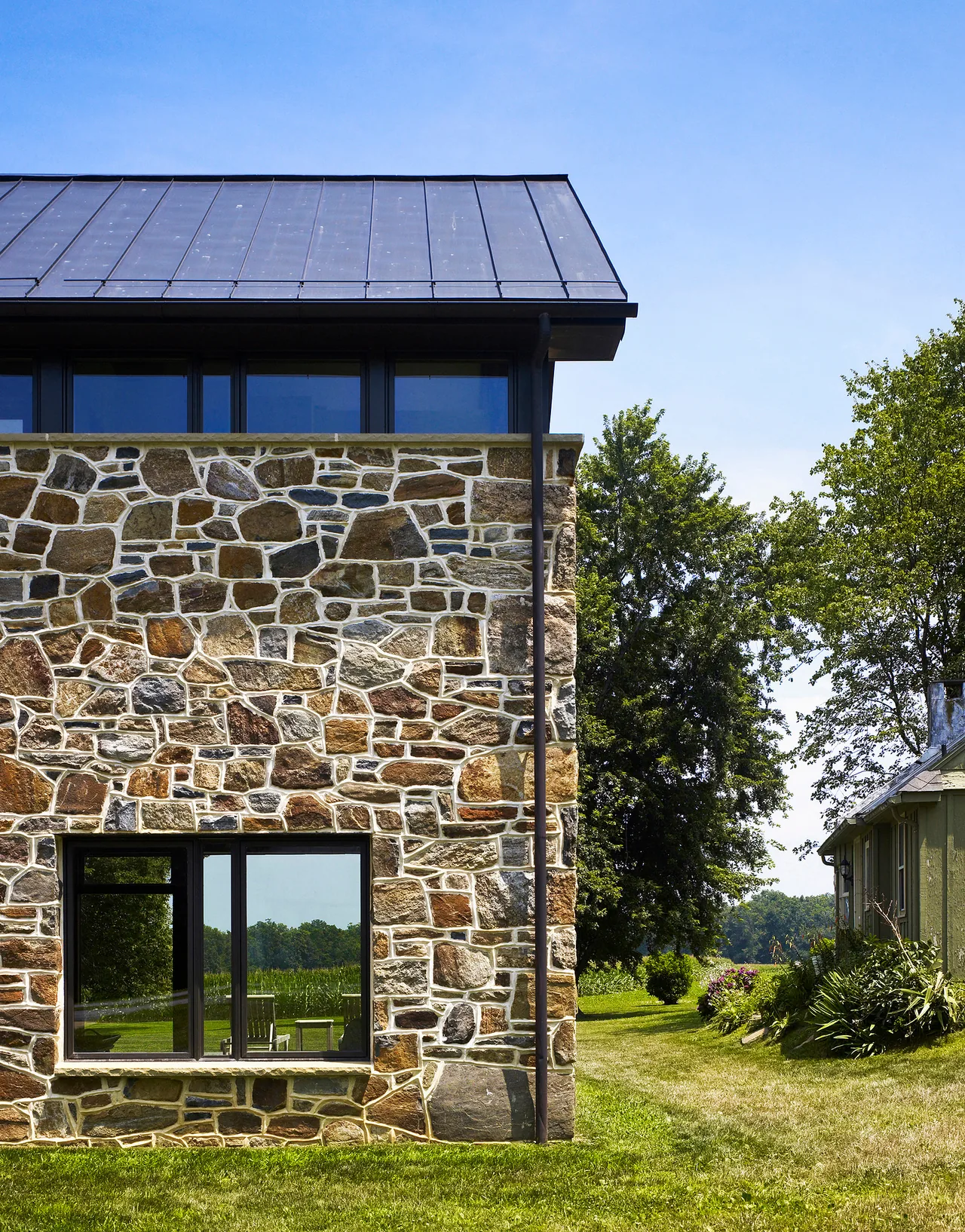 The Elverson Addition features a historic stone facade and a metal roof by Wyant Architecture.